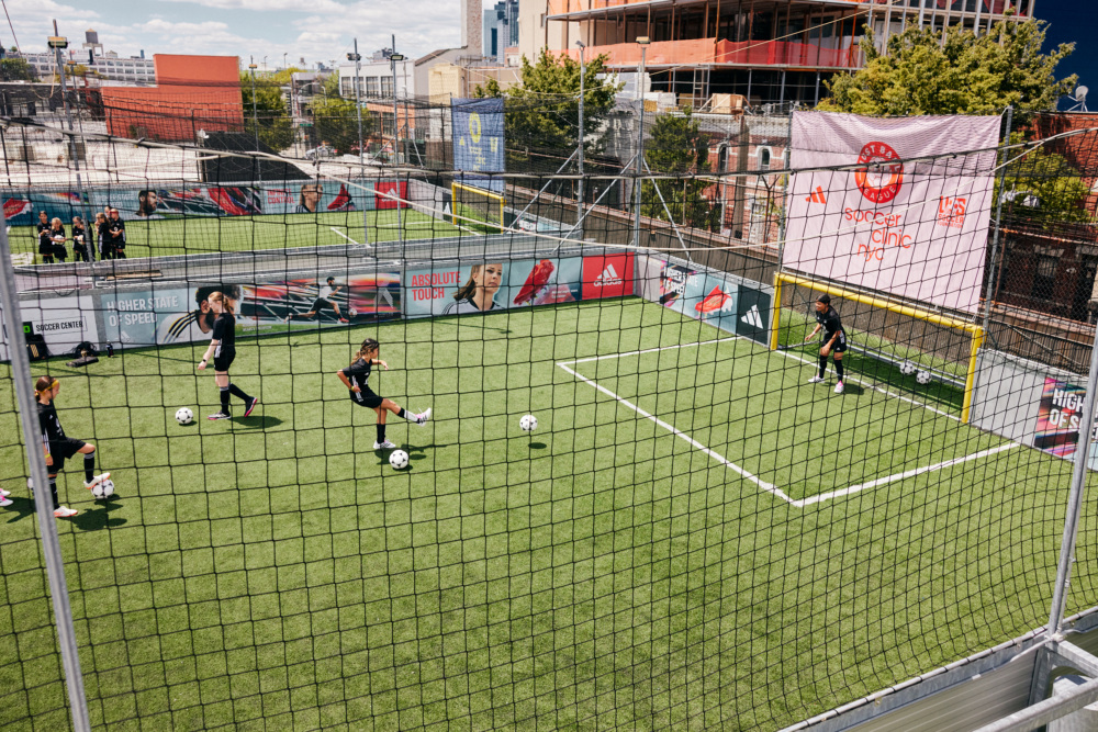 Girls play on a rooftop pitch in Queens New York City